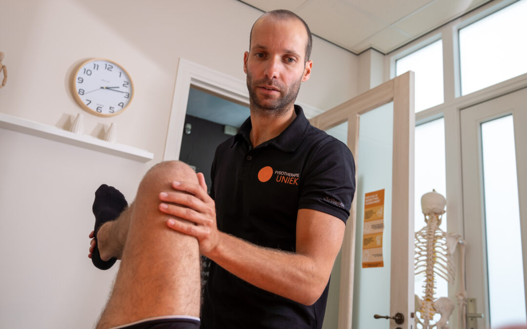 Fysiotherapeut van Fysiotherapie Uniek onderzoekt een knie bij artrose